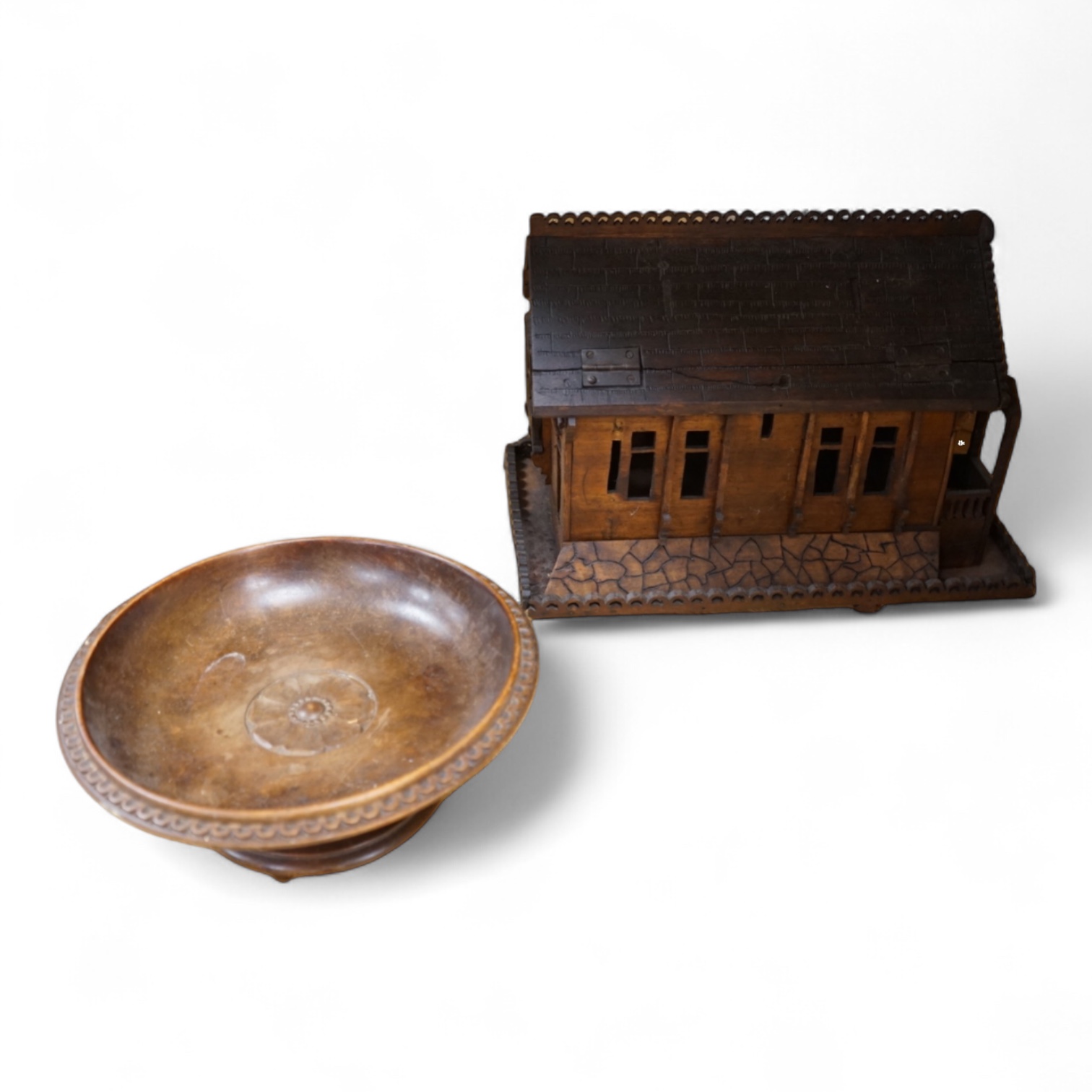 An early 20th century Black Forest carved walnut musical footed dish together with a model of a house (2)